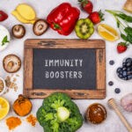 Natural immune booster foods shown together highlight how everyday ingredients like fruits, vegetables, herbs, and fermented foods support immune regulation rather than quick fixes.
