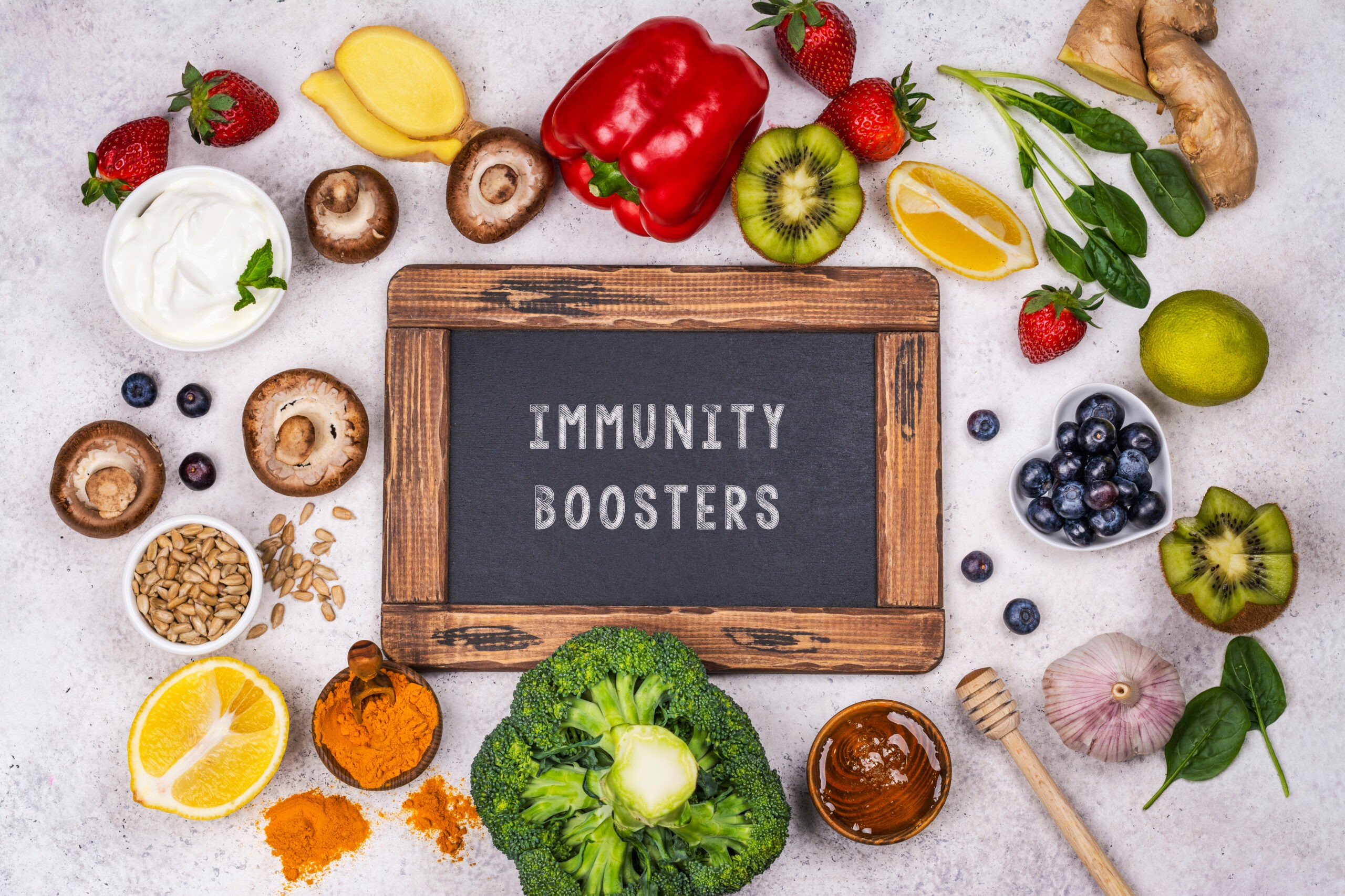 Natural immune booster foods shown together highlight how everyday ingredients like fruits, vegetables, herbs, and fermented foods support immune regulation rather than quick fixes.